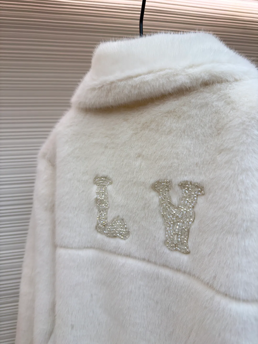 LOUIS VUITTON Turquoise Mink Jacket ●Original version: Purchased and developed at 147799 ●Item number: 1681421-C30 ●Fabric: mink fur fabric ●Technology: embroidery production ●Color: white ●Version: Fitted version ●Weight: about 1065 grams ●Size: 46-48-50-52 ●Description: This jacket is made of high-end imitation mink velvet fabric, which is soft and fluffy to the touch and has excellent warmth retention. The lapel design adopts three-dimensional tailoring + precision sewing technology, and the collar shape is crisp and naturally connected with the body. The placket button is a custom-made blue-green metal button, which creates a visual contrast with the white fabric. It is sewn in precise position and opens and closes smoothly. The large pockets on both sides use three-dimensional bag-shaped technology, and the bag mouth echoes the buttons, combining practicality and design. The inner lining is made of the brand's classic pattern printed fabric, which is combined with the outer layer of plush fabric through laminating sewing technology to create a strong sense of layering. The overall cut is a loose-shouldered version, and the multi-piece structure is spliced ​​to create a casual and trendy wearing effect while ensuring comfort and freedom during movement. It is a fashionable item that combines luxurious plush texture with exquisite craftsmanship. The overall wiring is straight and delicate, the fabric is comfortable and soft, and the color is consistent without color difference. It can be matched with the same style to create a fashionable look and control various occasions. Customized accessories, complete with three standards, same style for men and women!
